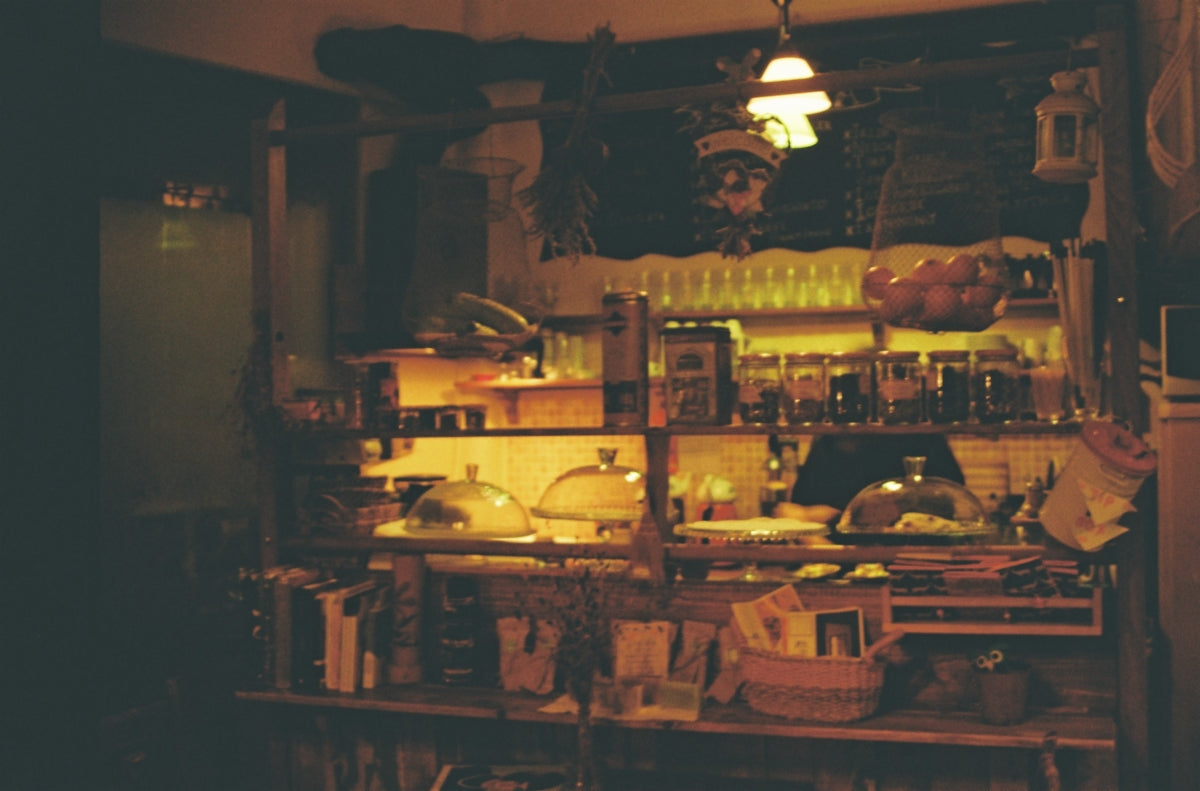 brown wooden shelf with bottles and cups
