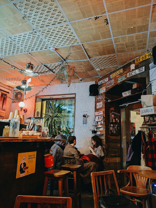 a group of people sitting at a table in a restaurant