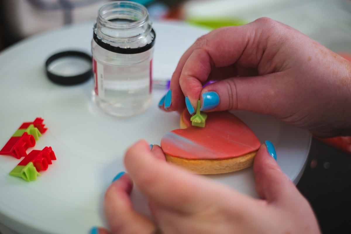 a person is decorating a piece of food