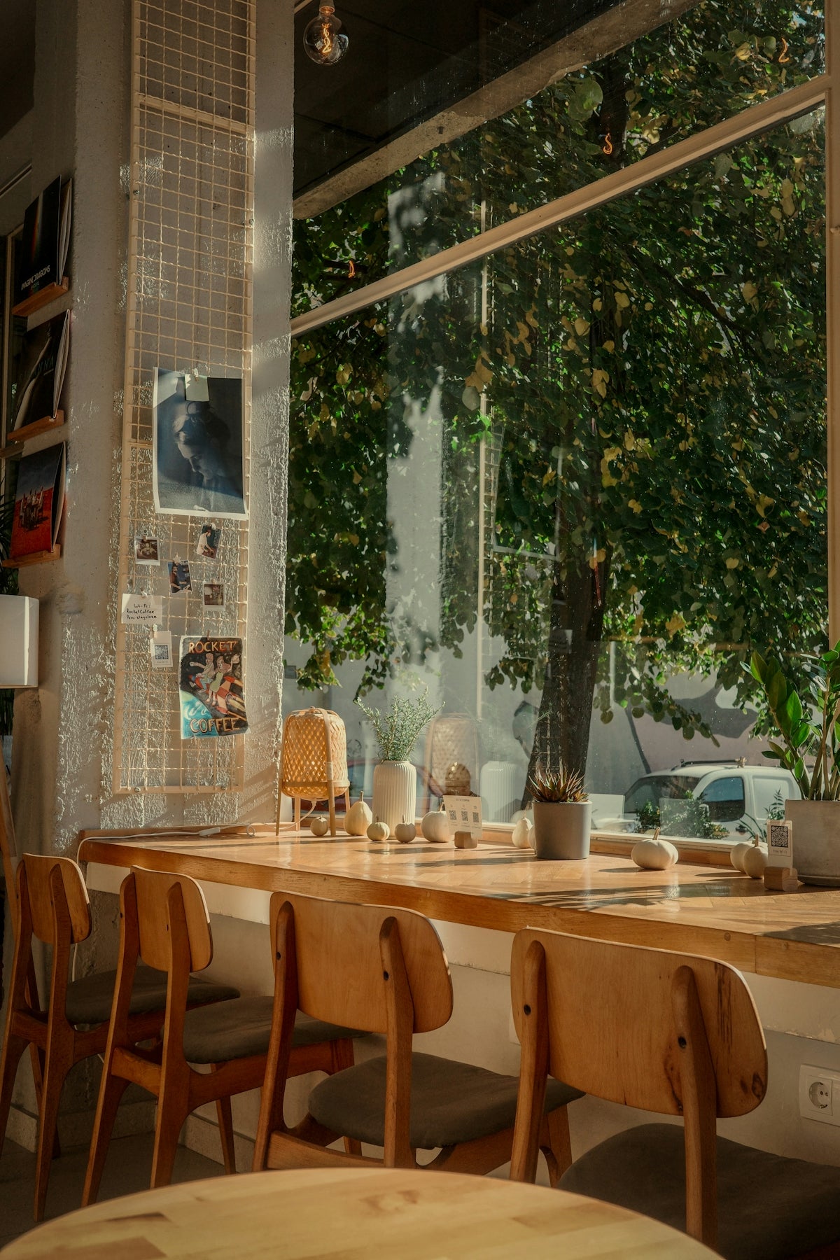 A dining room with a table and chairs and a large window